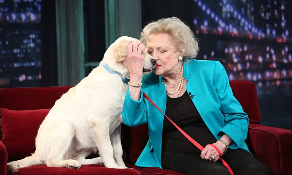 Woman with dog on a couch.