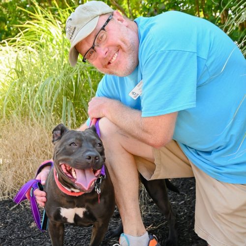 Person with a happy dog outdoors.